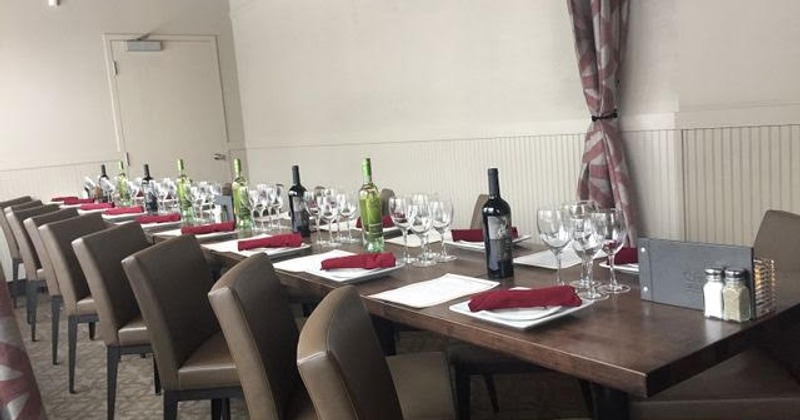 Interior, seating booths with tables, tables for four down the middle of the room