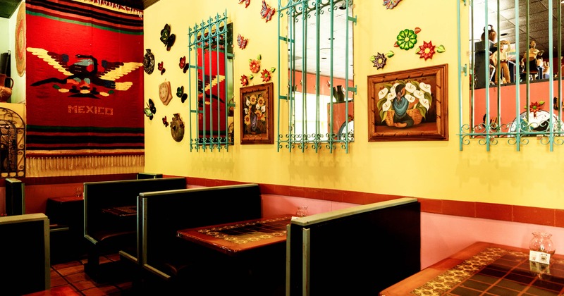 Interior with colorful wall decorations, mirrors, and booths