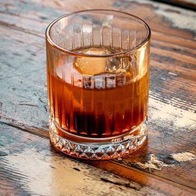 Old Fashioned cocktail on a wooden table.
