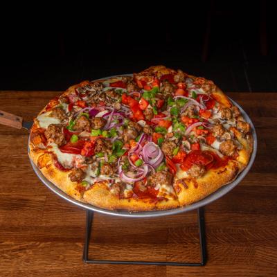 Loaded deluxe pizza topped with sausage, pepperoni, melted cheese, and peppers.