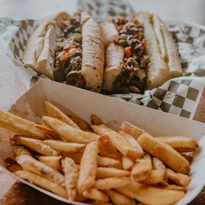 Cheesesteak sandwiches and fries.