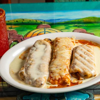 Stuffed poblano pepper, chimichanga and a burrito smothered in cheese sauce.