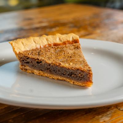 Chocolate Chess Pie slice on a white plate.