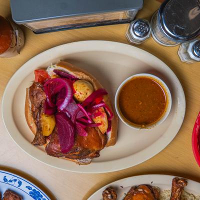 Torta filled with roasted chicken, beets, and potatoes, served with a savory sauce.