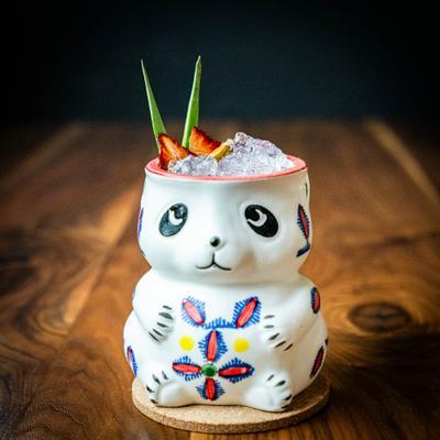 A cocktail drink served in a panda tiki cup.