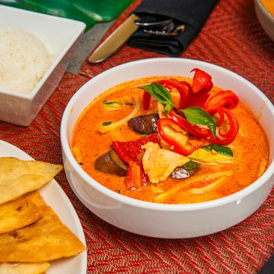 Red Curry with eggplant, bamboo shoots, bell pepper, zucchini and basil leaves.