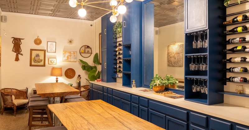 Cozy interior with wooden tables, chairs, artworks and a warm ambiance