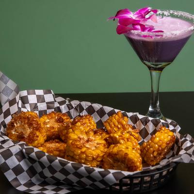 Fried Corn Wheels, served with a cocktail.