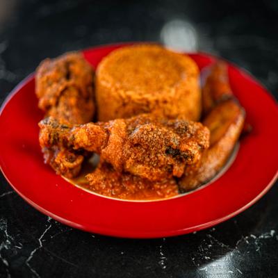 Stewed chicken with jollof rice.