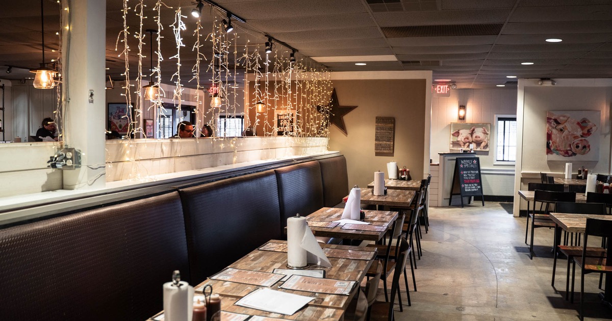 Interior, tables, chairs and brown leather benches