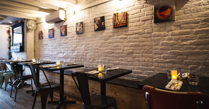 Dining area, tables and seats, pictures on the wall