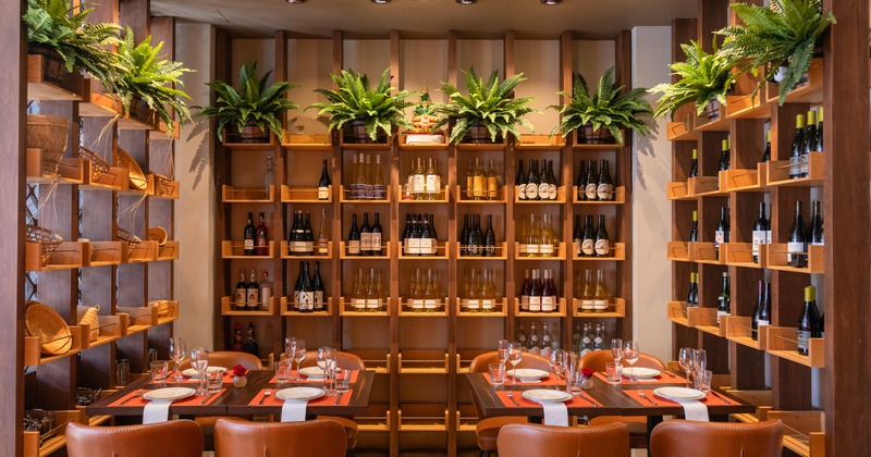 Dining tables and wine bottles on the shelves