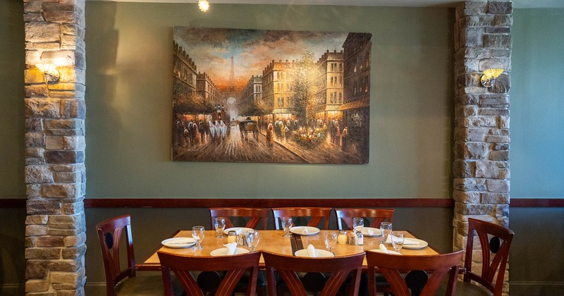 Interior, table ready for guests, a picture on the wall