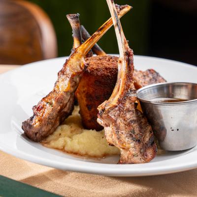 Lamb Lollipops with a side of creamy polenta and a dipping sauce.
