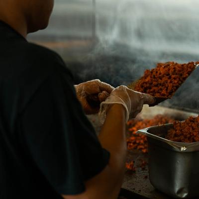 A staff member cooking food.