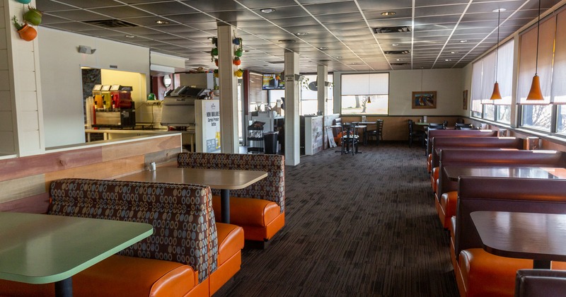 Interior, lined up bench seating with tables