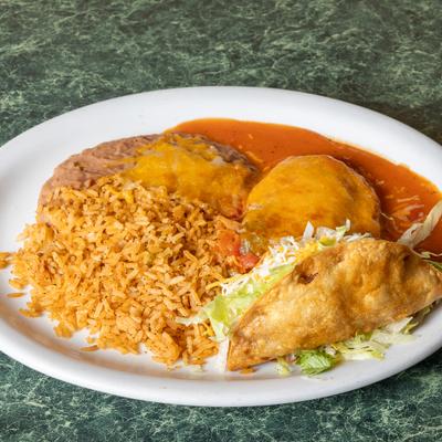 Mexican-style plate featuring a chile relleno, a crispy taco, refried beans, and rice.