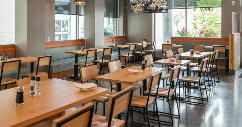 Interior, dining area, wooden top tables and chairs, banquette bench