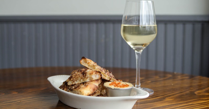 Dirty bread and hummus, accompanied with white wine