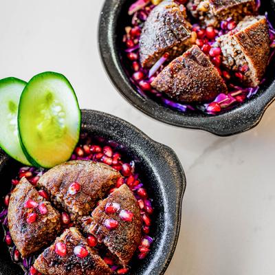 Two portions of grilled kebbeh, top down view.