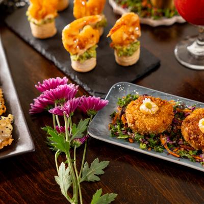 Assorted food plates with flowers on a table.