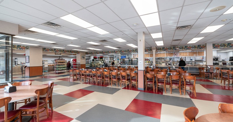 Interior, seating area, colorful tile flooring, kitchen and preparing station in the back