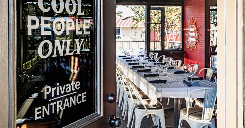 Interior, private room entrance with a view of a set table inside