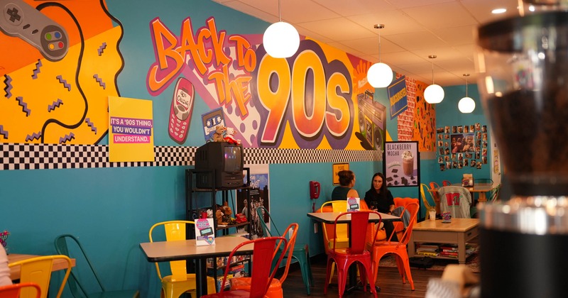 Seating area with the 90s themed wall mural