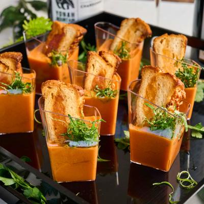 grilled cheese and tomato soup shooters on black tray.