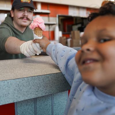 child receiving ice cream cone.