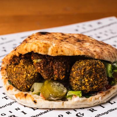 Falafel pita sandwich with pickles.