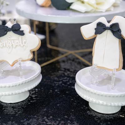 Formal outfit cookies decorated with black bow details.