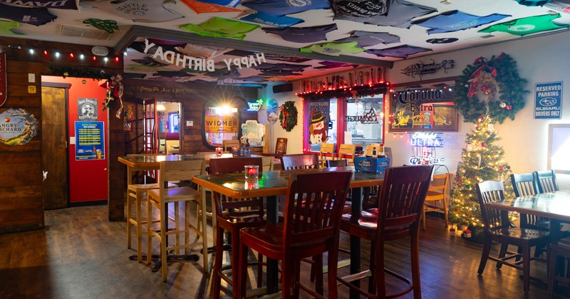 Interior, high seating area, wooden top tables with wooden stools, tables for four