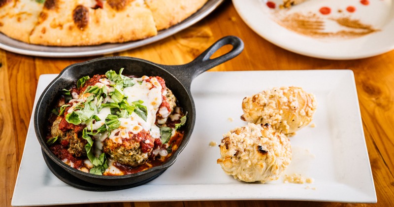 Homemade red sauce with fresh mozzarella, homemade meatballs and a roasted pepper