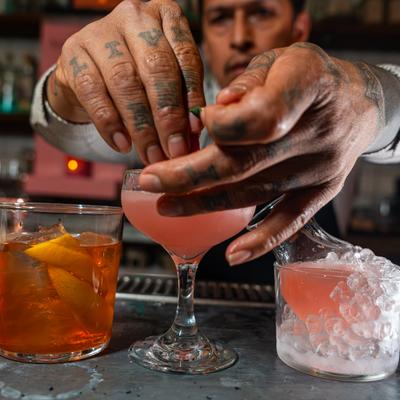 Hands preparing cocktails.