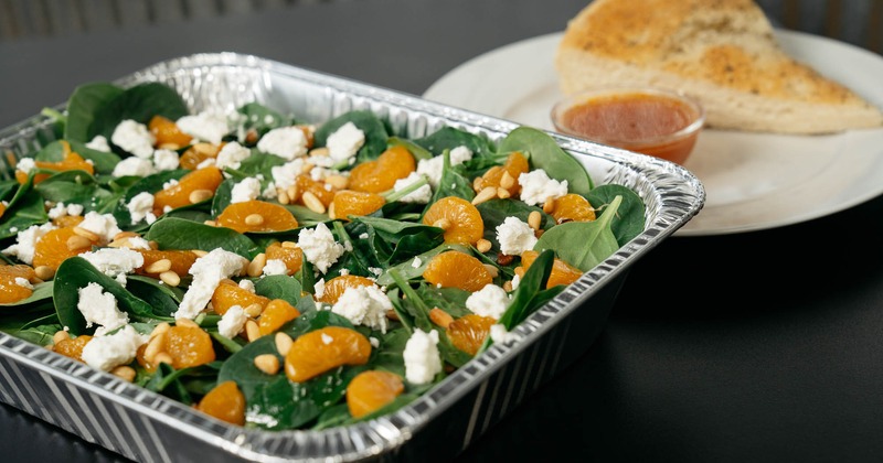 Spinach salad, with roasted pine nuts, mandarin oranges, and goat cheese