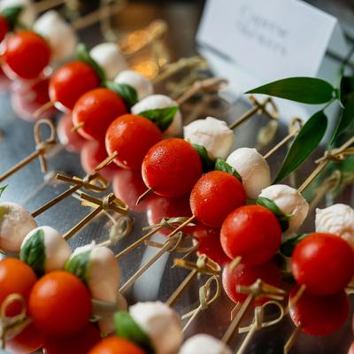 Caprese skewers with tomatoes, mozzarella, and basil.