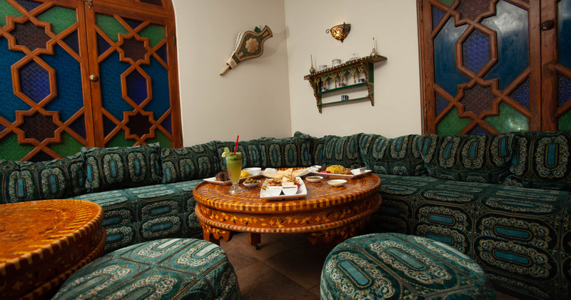 Interior, traditional design of L sofa, table and a wall decoration