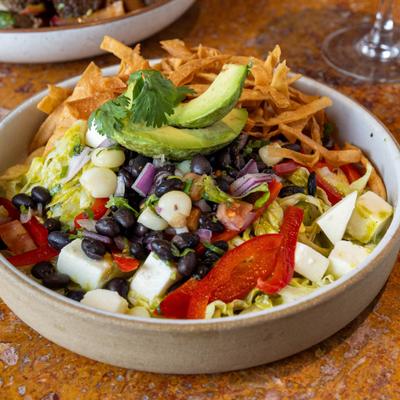 Salad with veggies and tortilla strips.