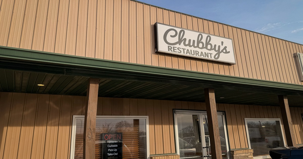 Exterior, angle view to front restaurant, entrance, sign above
