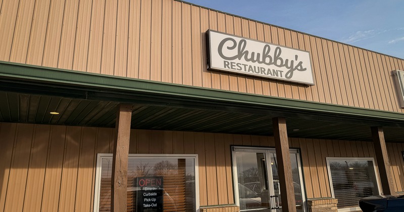 Exterior, angle view to front restaurant, entrance, sign above