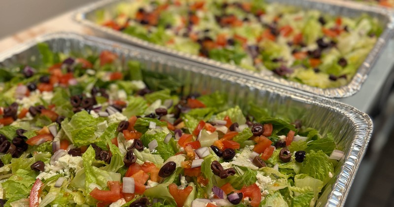 Catering trays of chopped salad with vegetables and dried fruit