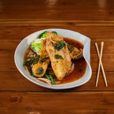 Battered deep-fried tilapia in sweet and sour sauce.