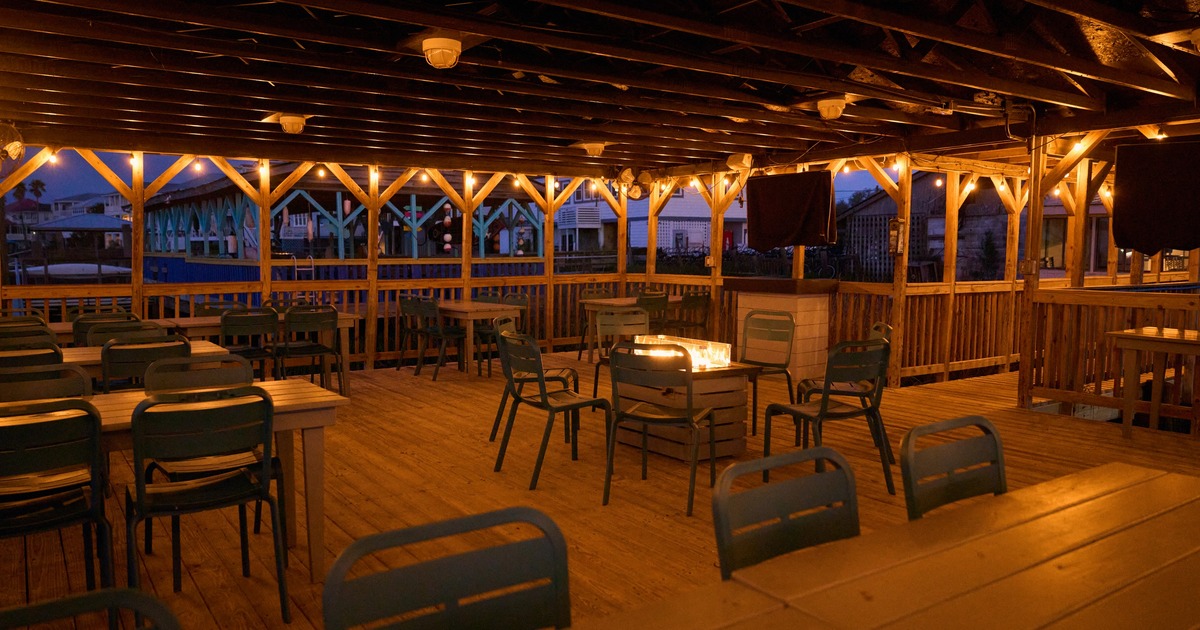Exterior, outdoor patio with roof, dining area with wooden floors, chairs and tables