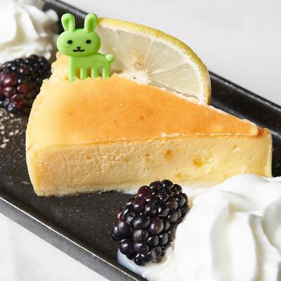 Yuzu Cheesecake plate with whipped cream,  blackberry and lemon slice garnish.