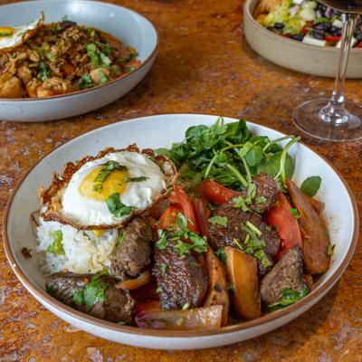 Stir fried beef with veggies and sunny side up egg.