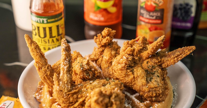 Crispy fried chicken wings served over waffles