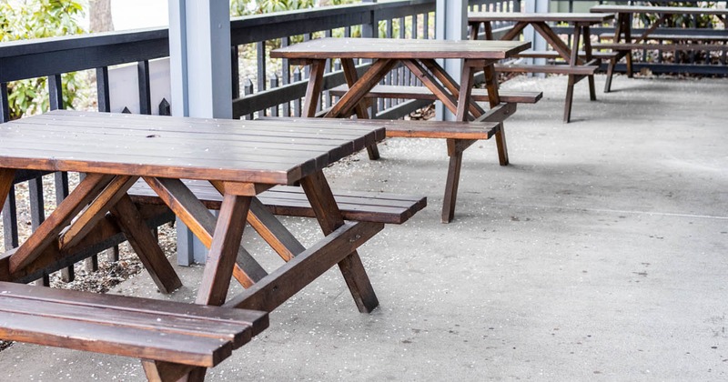 Exterior area, conjoined wooden tables and benches