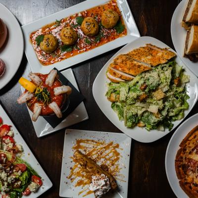 Assortment of dishes arranged on a wooden table, overhead view.
