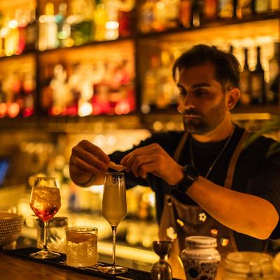 Bartender garnishing a cocktail.
